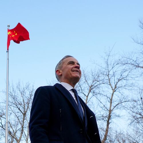 Prime Minister Mark Carney walks past a Chinese flag as he leaves after holding a press conference in Ritan Park in Beijing, China on Friday, Jan. 16, 2026. (Sean Kilpatrick /The Canadian Press via AP)