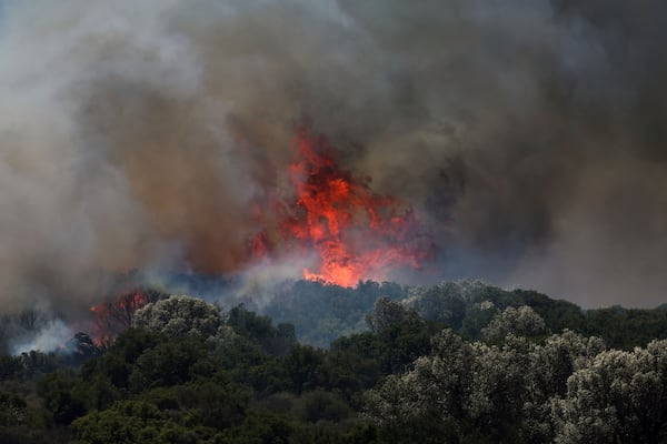A fire rages across a forest area in Cesme, near Izmir, Turkey, Thursday, July 3, 2025. (Cengiz Malgir/Dia Photo via AP)