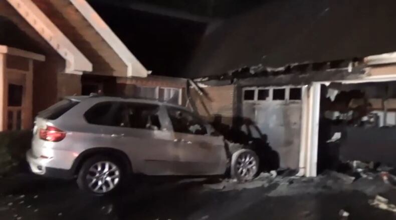 A fire that started in this SUV spread to the house early Friday in Gwinnett County.