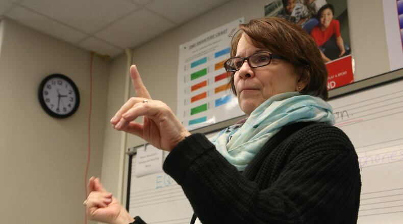 Sandy Springs Charter Middle School band director Janet Stalling conducts her students during a class. The middle school is in Fulton County, which is one of six Georgia school districts that won national recognition for its music education program this week. (HENRY TAYLOR / HENRY.TAYLOR@AJC.COM)