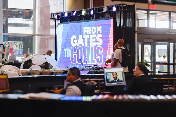 A screen marks the "From Gates to Goals" exhibit celebrating the upcoming FIFA World Cup at Hartsfield-Jackson Atlanta International Airport's international terminal. (Arvin Temkar/AJC)