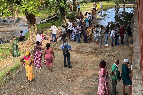 Voters queue to cast their votes for the presidential elections outside a polling station, in Liberville, Gabon, Saturday, April 12, 2025. (AP Photo/Betines Makosso)