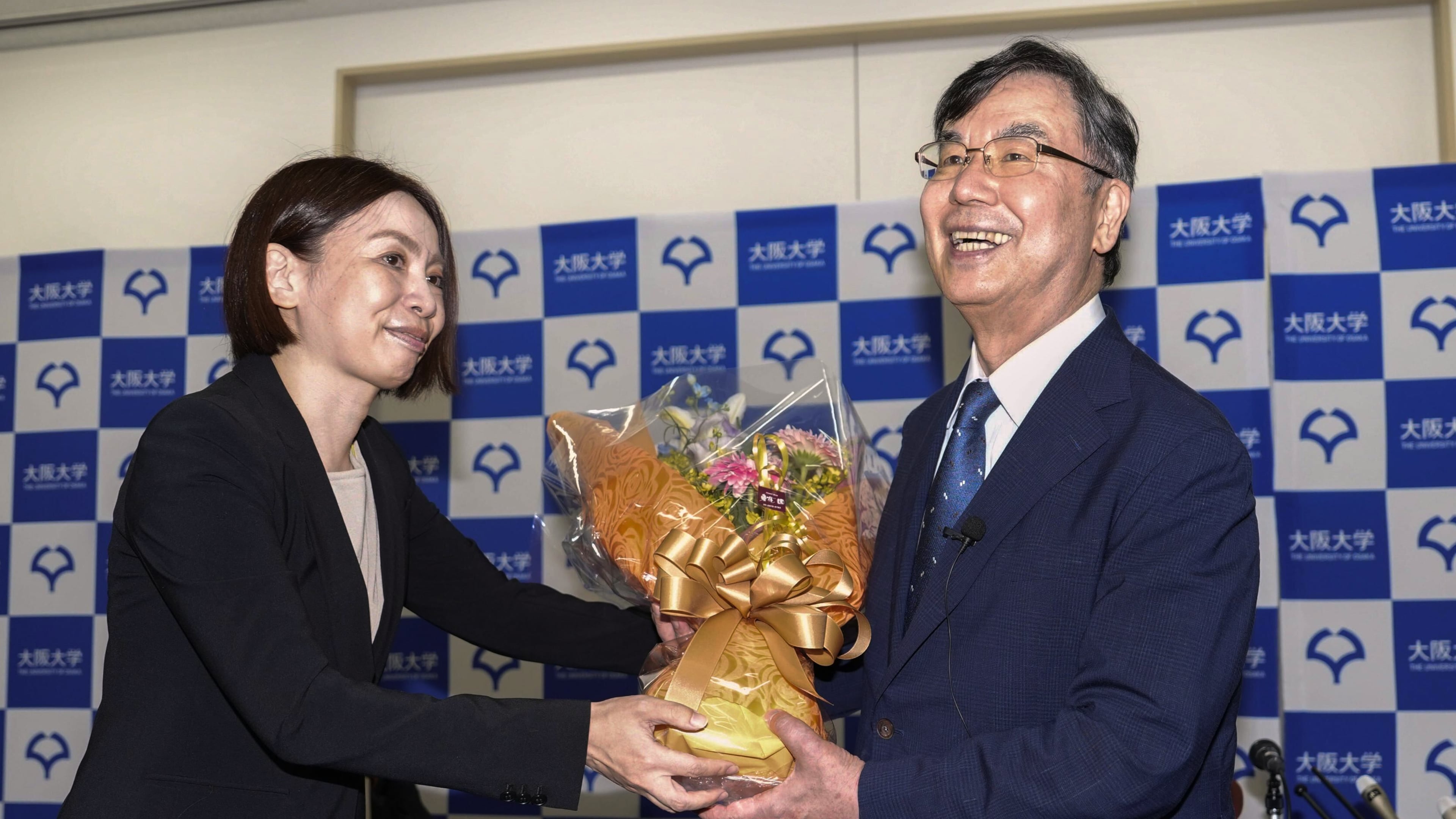 Osaka University professor Dr. Shimon Sakaguchi, right, receives flowers at a news conference in Suita, near Osaka, western Japan, Monday, Oct. 6, 2025, after he won the Nobel Prize in medicine. (Shohei Miyano/Kyodo News via AP)