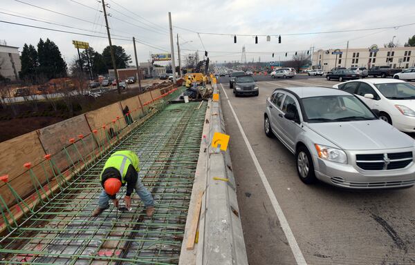 January 29, 2013 Duluth - Dustin Sloan of E.R. Snell Contractor works on diverging diamond at the Pleasant Hill Road overpass along the I-85 expressway in Gwinnett County on Tuesday, Jan. 29, 2013. Gwinnet County has a lot riding on its Special Purpose Local Option Sales Tax when it hits ballots in November - about $148 million a year, to be exact. This could be the toughest SPLOST vote in the county's history, given the series of scandals which included the county commissioners using SPLOST money to buy overpriced parkland from their developer buddies. HYOSUB SHIN / HSHIN@AJC.COM