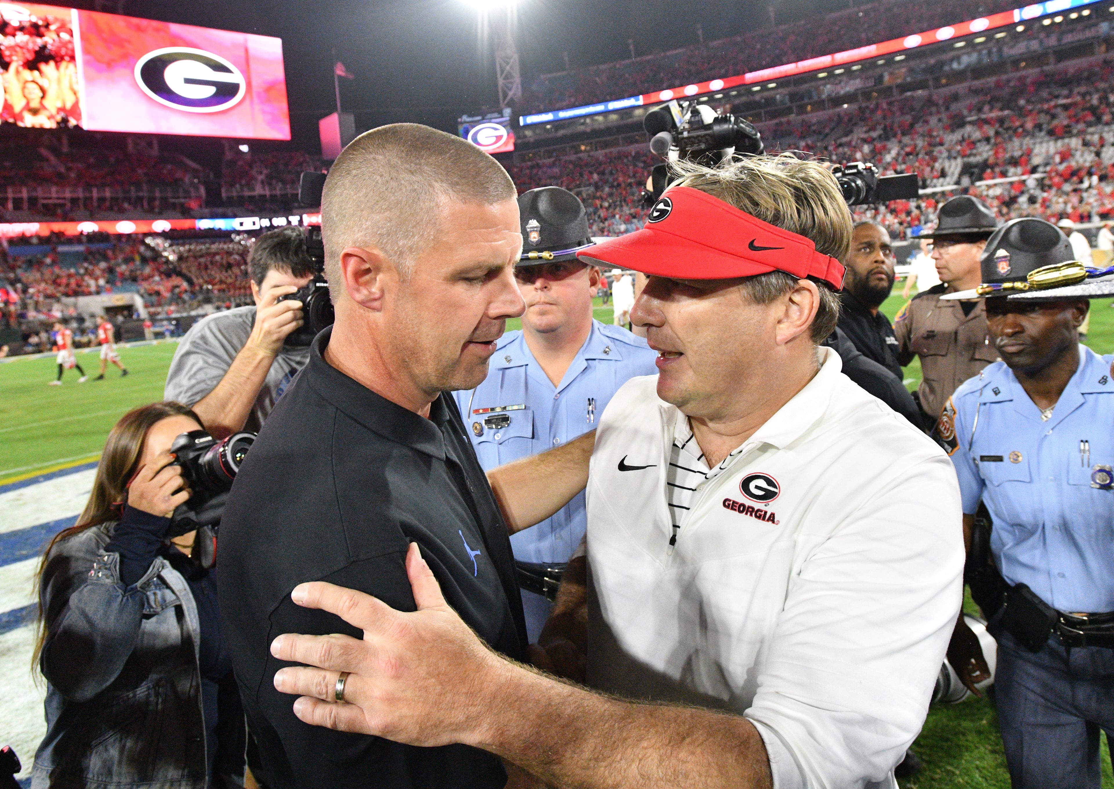 Florida's Billy Napier (left) and Georgia's Kirby Smart after a recent edition of the World's Largest Outdoor Cocktail Party in Jacksonville, Fla.