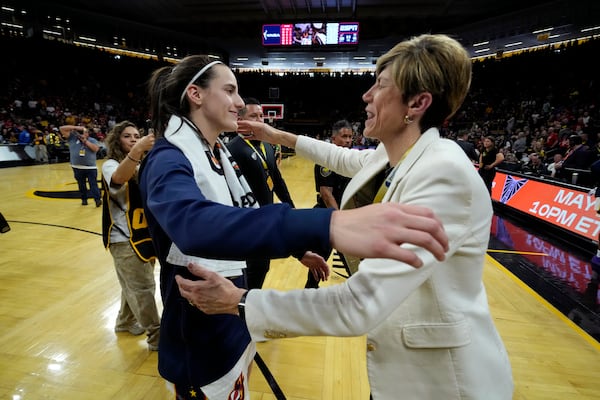Indiana Fever guard Caitlin Clark, left, hugs Iowa coach Jan Jensen, right, after an exhibition women's basketball game against Brazil, Sunday, May 4, 2025, in Iowa City, Iowa. (AP Photo/Charlie Neibergall)