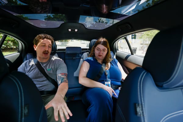 Ethan Teicher, a spokesman for Waymo, explained many features of the Waymo self-driving vehicle to an AJC intern reporter, Allison Mawn, during a test drive on Monday, June 23, 2025. 
(Miguel Martinez/ AJC)