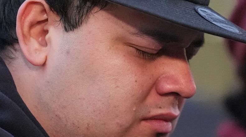 Kilmar Abrego Garcia cries during a rally ahead of a mandatory check at the Immigration and Customs Enforcement office in Baltimore, Friday, Dec. 12, 2025, after he was released from detention on Thursday under a judge's order. (AP Photo/Stephanie Scarbrough)