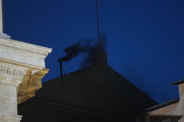 Black smoke billows from the chimney of the Sistine Chapel during the cardinals' conclave to elect a new pope, at the Vatican, Wednesday, May 7, 2025. (AP Photo/Alessandra Tarantino)