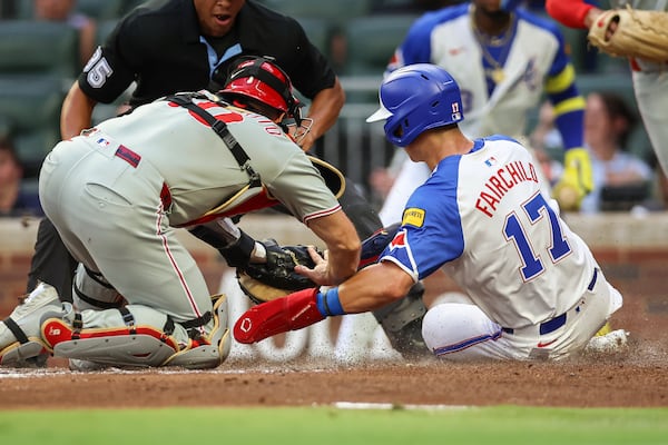 Philadelphia Phillies catcher J.T. Realmuto, left, tags out Atlanta Braves' Stuart Fairchild (17) at the plate in the second inning of a baseball game, Saturday, June 28, 2025, in Atlanta. (AP Photo/Colin Hubbard)