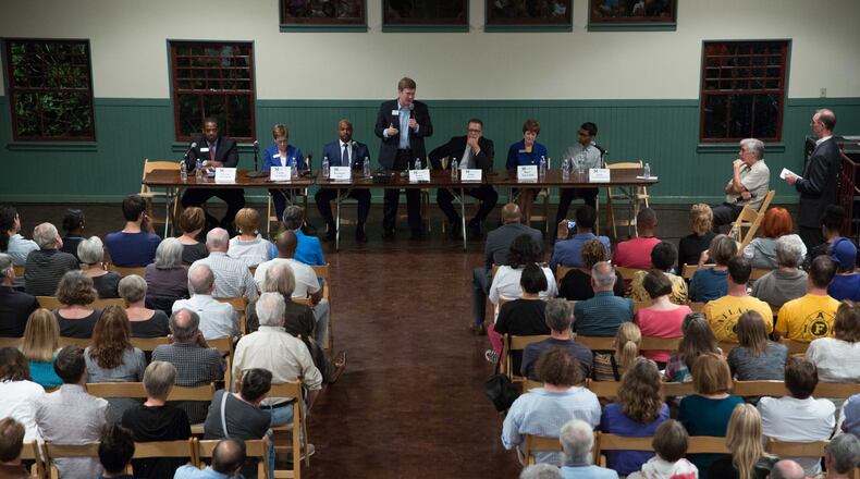 Atlanta mayoral candidate Peter Aman (center), a former city chief operating officer, talks during an Inman Park mayoral candidate forum in The Trolley Barn, Wednesday, Oct. 4, 2017, in Atlanta. Seven of the nine major mayoral candidates have ties to City Hall. BRANDEN CAMP / SPECIAL