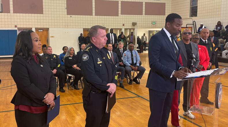(Left to right) Fulton County District Attorney Fani Willis and Atlanta Police Chief Darin Schierbaum listen as Atlanta Mayor Andre Dickens talks about crime reduction last week. (Jozsef Papp/AJC)
