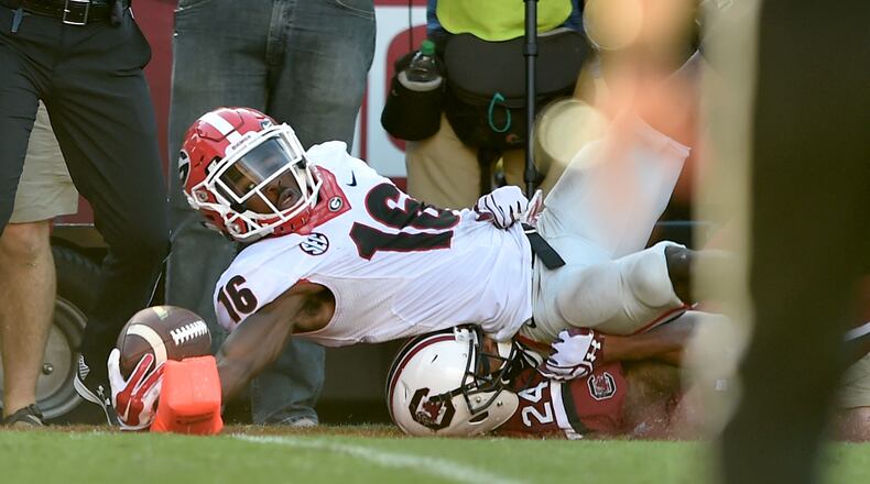 Georgia Bulldogs wide receiver Isaiah McKenzie reaches into the end zone for a touch down in front of South Carolina Gamecocks defensive back D.J. Smith. BRANT SANDERLIN/BSANDERLIN@AJC.COM