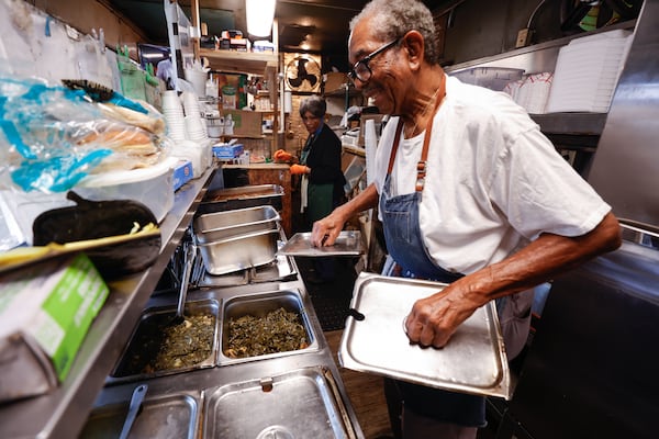 Oscar Wyatt works in the kitchen alongside his wife, Addie, at Sgt. Wyatt’s Country BBQ in Atlanta. So how does a little building and its menu of country food remain steadfast for four decades? “By the grace of God and the good food,” Wyatt says. (Natrice Miller/AJC)