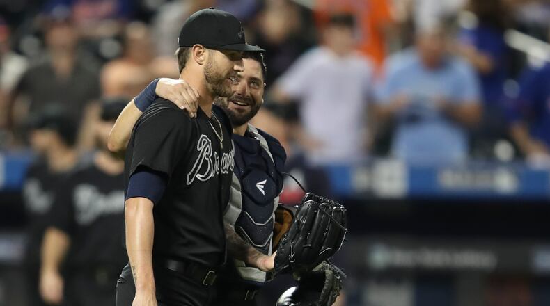 Atlanta Braves relief pitcher Shane Greene, left, and catcher Francisco Cervelli smiles after the  team's 9-5 win over theNew York Mets in a baseball game Saturday, Aug. 24, 2019, in New York. (AP Photo/Mary Altaffer)