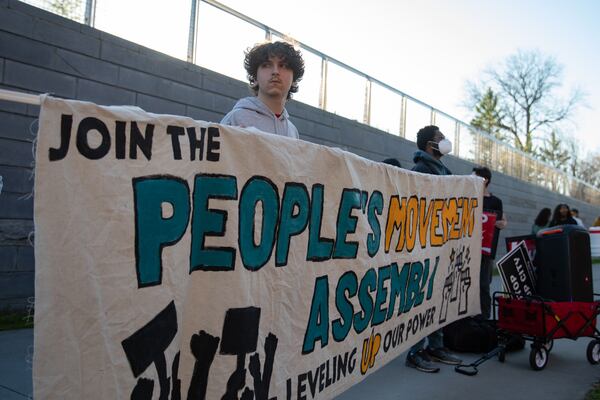 Protesters with the People's Movement Assembly gather outside Atlanta Mayor Andre Dickens' reelection launch party on March 11, 2025, to demand officials count signatures submitted as part of the Public 
Safety Training Center referendum. (Riley Bunch/riley.bunch@ajc.com)