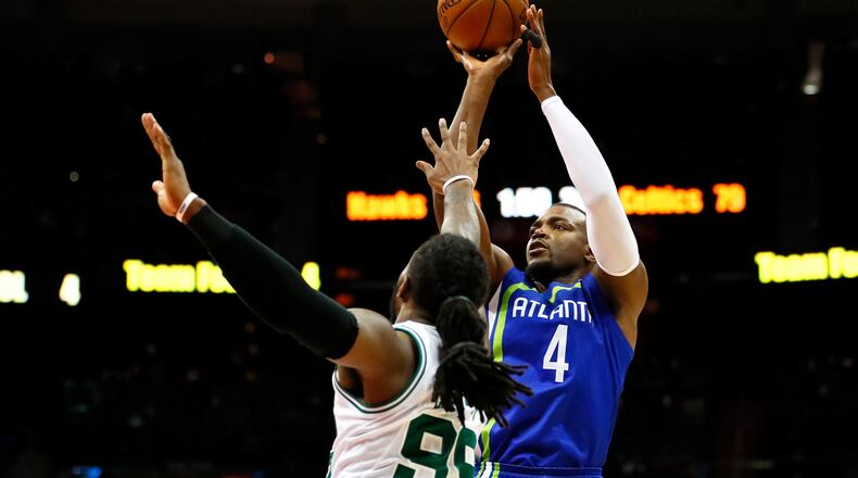 Atlanta Hawks forward Paul Millsap (4) shoots as Boston Celtics forward Jae Crowder (99) defends in the second half of an NBA basketball game on Thursday, April 6, 2017, in Atlanta. The Hawks won the game 123-116. (AP Photo/Todd Kirkland)