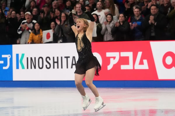 Kaori Sakamoto, of Japan, reacts after performing during the women's free skating program at the figure skating world championships, Friday, March 28, 2025, in Boston. (AP Photo/Charles Krupa)
