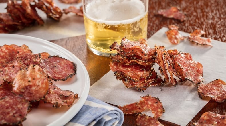 Peppered salami is sliced thinly then cooked in the oven. They become crisp as they cool, making an addictive snack. (Food styling by Mark Graham.) (Zbigniew Bzdak/Chicago Tribune/TNS)