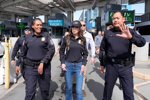 Homeland Security Secretary Kristi Noem, center, and Sidney Aki, director of field operations for the Customs and Border Protection (CBP) San Diego field office, right, walk to the border during a tour of the San Ysidro Port of Entry, Sunday, March 16, 2025, in San Diego. (AP Photo/Alex Brandon)