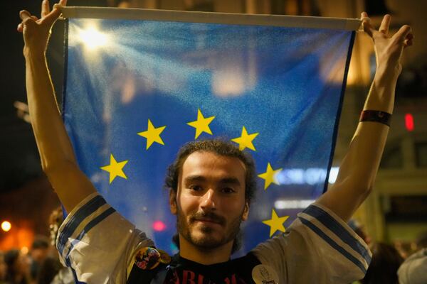 Supporters of Presidential candidate Nicusor Dan celebrate on the street after polls closed for the second round of the country's presidential election redo in Bucharest, Romania, Monday, May 19, 2025. (AP Photo/Andreea Alexandru)