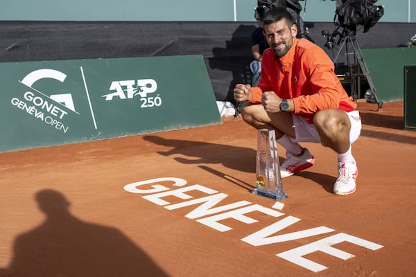 Winner Novak Djokovic of Serbia poses with the trophy after the final match of the ATP 250 Geneva Open tennis against Hubert Hurkacz of Poland, in Geneva, Switzerland, Saturday, May 24, 2025. (Martial Trezzini/Keystone via AP)
