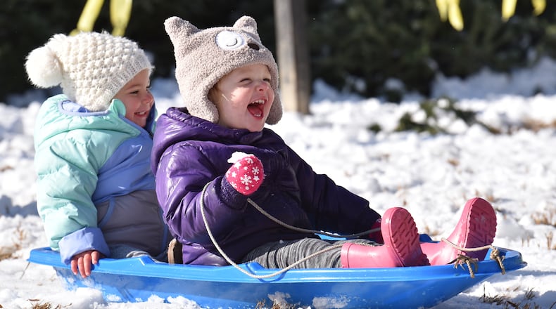 December 9, 2017 Decatur - Nora Joiner (right), 2, and Norah Knight, 2, make their way down the hill in Decatur on Saturday, December 9, 2017. HYOSUB SHIN / HSHIN@AJC.COM