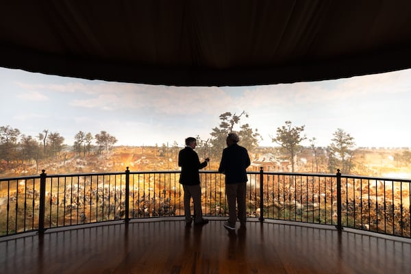 President and CEO Sheffield Hale (left) speaks to AJC reporter Ernie Suggs at the Cyclorama exhibit inside the Atlanta History Center. The cycloramic painting, completed in 1886, was housed for years near Zoo Atlanta in Grant Park. (Arvin Temkar/AJC 2025)