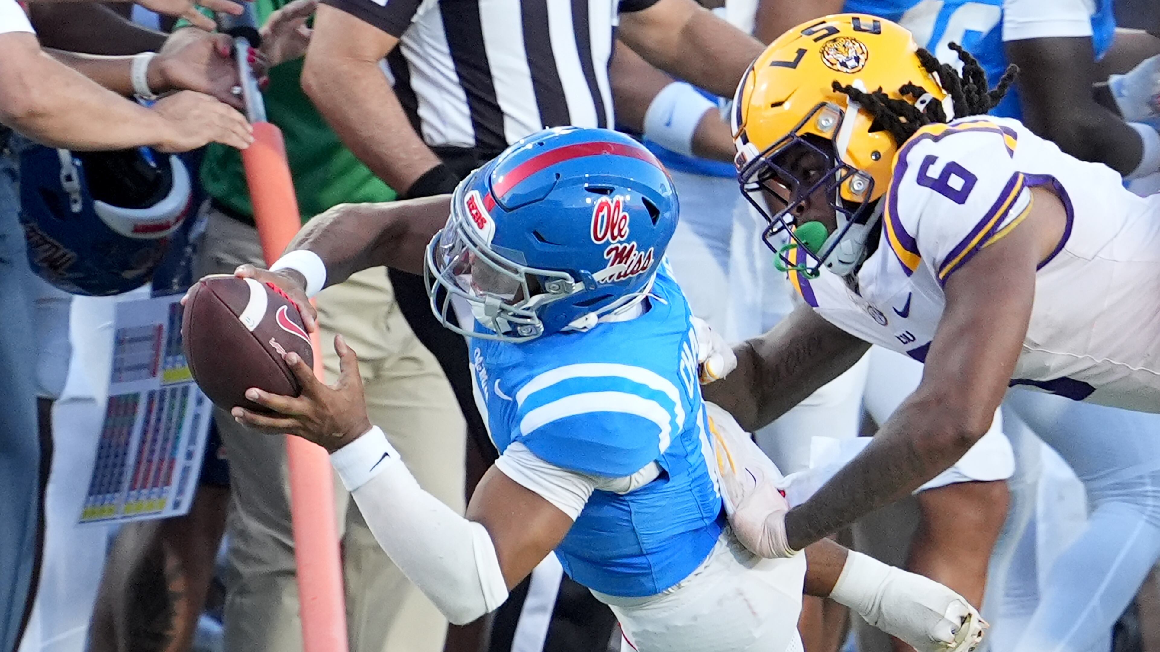 Mississippi quarterback Trinidad Chambliss (6) dives for a first down while LSU defensive end Patrick Payton (6) tackles him during the second half of an NCAA college football game in Oxford, Miss., Saturday, Sept. 27, 2025. (AP Photo/Rogelio V. Solis)