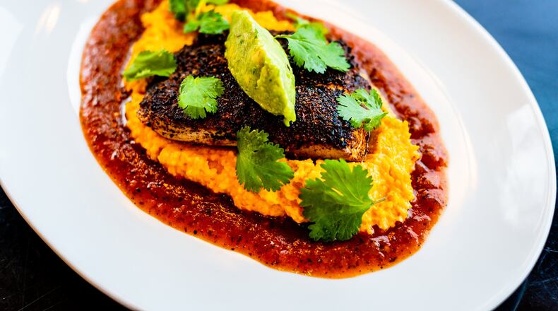 Mahi Mahi with Smoked Tomato Grits at Buckhead Diner. CONTRIBUTED BY HENRI HOLLIS