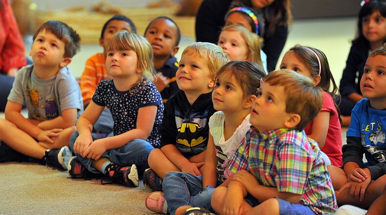 Children at Open Arms Lutheran Child Development Center listen to a story read by Bobby Cagle, commissioner of the state Department of Early Care. Cagle and Georgia's First Lady, Sandra Deal read a story to the children Monday September 30, 2013 to help kickoff Georgia Pre-K Week.