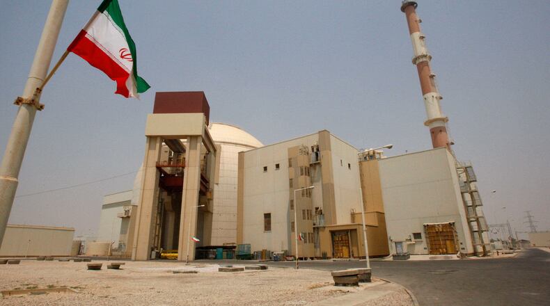 FILE - An Iranian flag flutters in front of the reactor building of the Bushehr nuclear power plant, just outside the southern city of Bushehr, Iran, Aug. 21, 2010. (AP Photo/Vahid Salemi, File)