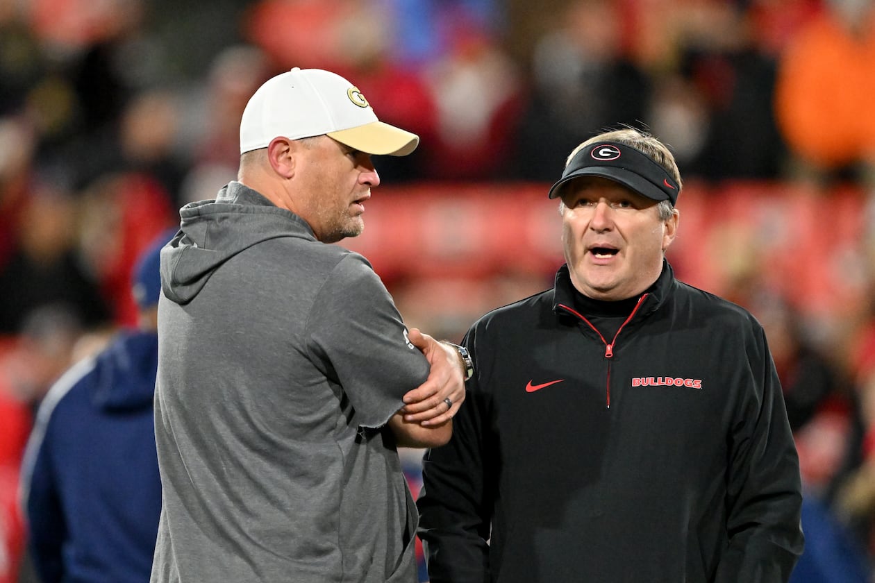 Georgia Tech's Brent Key (left) and Georgia's Kirby Smart — pictured chatting before the 2024 matchup between the teams — both still have a shot at making their conference title games. The Bulldogs need Texas A&M to lose to Texas or Alabama to lose to Auburn, and the Yellow Jackets need losses by Southern Methodist, Pitt and Virginia. (Hyosub Shin/AJC 2024)