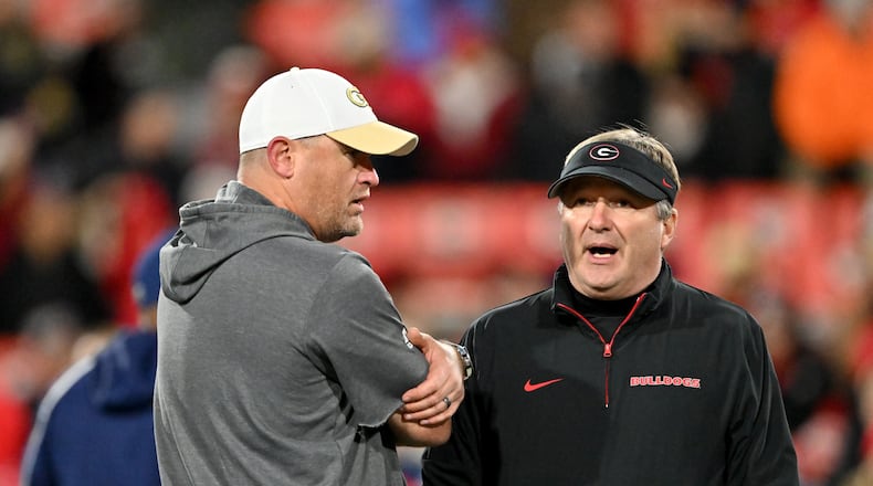 Georgia Tech head coach Brent Key (left) and Georgia head coach Kirby Smart chat before an NCAA football game between Georgia and Georgia Tech at Sanford Stadium, Friday, November 29, 2024, in Athens. (Hyosub Shin / AJC)