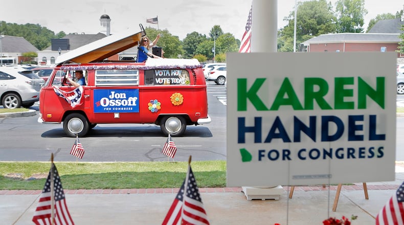 A campaign van for Jon Ossoff passes by a sandwich shop in Dunwoody last week, minutes after Karen Handel greeted supporters there. Both are candidates in the Sixth District runoff election. BOB ANDRES /BANDRES@AJC.COM