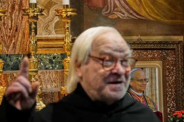 Augustinians order Friar Alberto Giovannetti backdropped by a picture of Pope Leo XIV, gestures during an interview with the Associated Press in the Sanctuary of Our Mother of Good Counsel, in Genazzano, Italy, Thursday, May 15, 2025. (AP Photo/Gregorio Borgia)