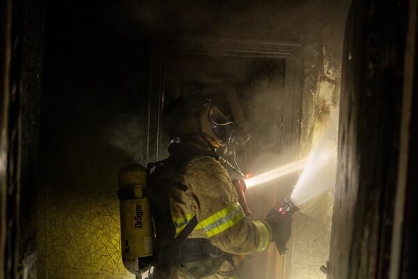 Firefighters extinguish a fire in a residential building damaged after a Russian attack in Kyiv, Ukraine, Saturday, May 24, 2025 (AP Photo/Alex Babenko)