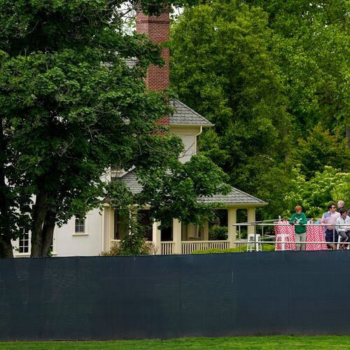 Fans watch from outside the fence line along the first fairway during the second round of the PGA Championship golf tournament at Aronimink Golf Club, Friday, May 15, 2026, in Newtown Square, PA. (AP Photo/Carolyn Kaster)