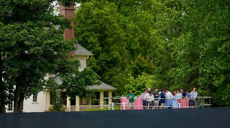 Fans watch from outside the fence line along the first fairway during the second round of the PGA Championship golf tournament at Aronimink Golf Club, Friday, May 15, 2026, in Newtown Square, PA. (AP Photo/Carolyn Kaster)