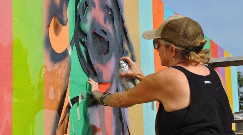 Artist Linda Mitchell finishes her painting on a skatepark wall along the Atlanta Beltline. Days later, her work was ravaged by people who were not fans.