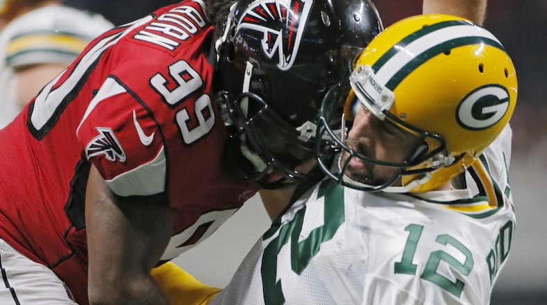 9/17/17 - Atlanta, GA - Atlanta Falcons defensive end Adrian Clayborn hits Green Bay Packers quarterback Aaron Rodgers as he throws. Atlanta Falcons vs Green Bay Packers. The Falcons opened the roof for the Falcons season opener at Mecedes-Benz Stadium. BOB ANDRES /BANDRES@AJC.COM