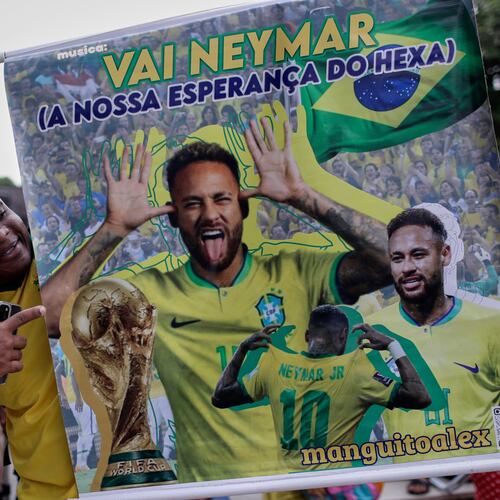 A fan poses with a poster of Brazilian soccer player Neymar, reading in Portuguese "Go Neymar, our hope for a sixth World Cup title" before Brazil's 2026 World Cup squad is announced, in Rio de Janeiro, Monday, May 18, 2026. (AP Photo/Bruna Prado)