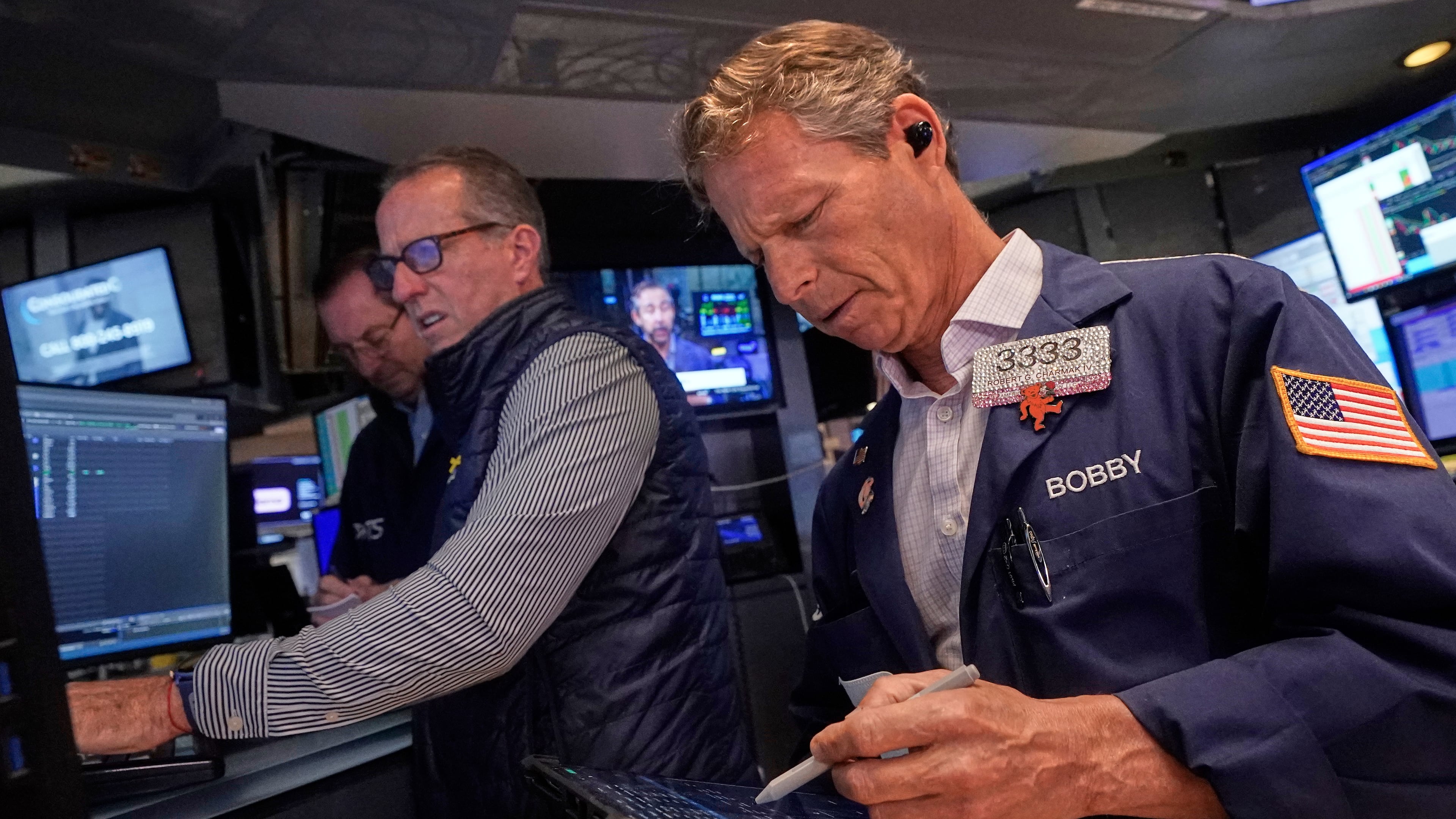 Trader Robert Charmak, right, and specialist Glenn Carell, center, work on the floor of the New York Stock Exchange, Wednesday, Sept. 10, 2025. (AP Photo/Richard Drew)