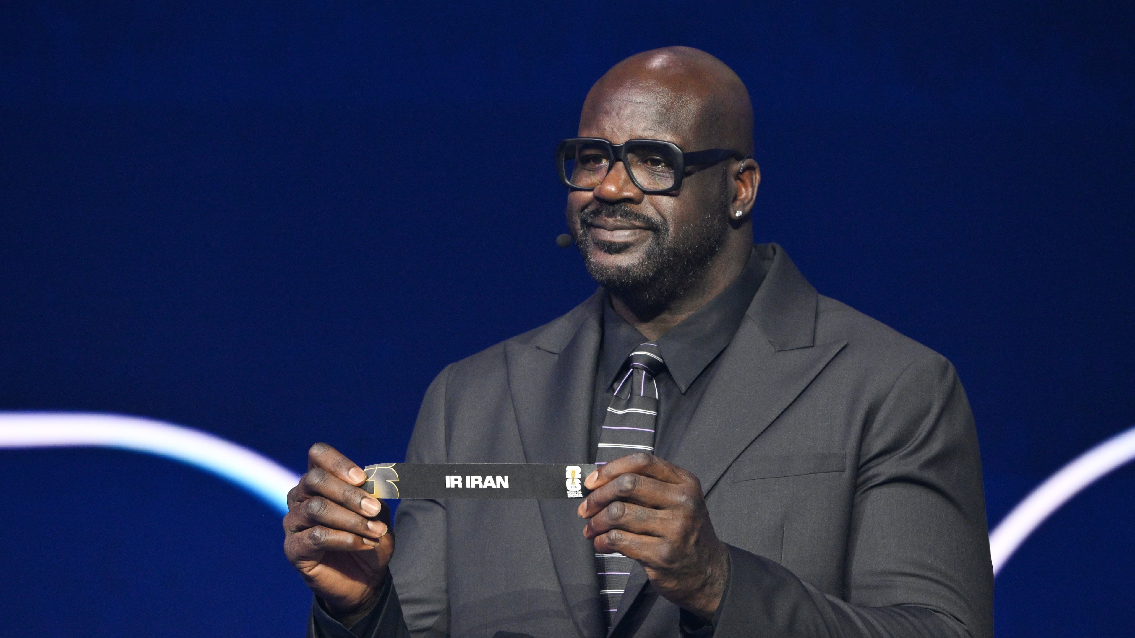 Former NBA player Shaquille O'Neal holds up Iran after drawing from a pot during the draw for the 2026 soccer World Cup at the Kennedy Center in Washington, Friday, Dec. 5, 2025. (Mandel Ngan/Pool Photo via AP)
