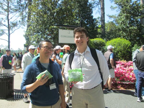 AJC sports writers Ken Sugiura (left) and Jack Leo show off chicken salad sandwiches at Augusta National Golf Club on April 8, 2025. (Photo courtesy of Ken Sugiura)