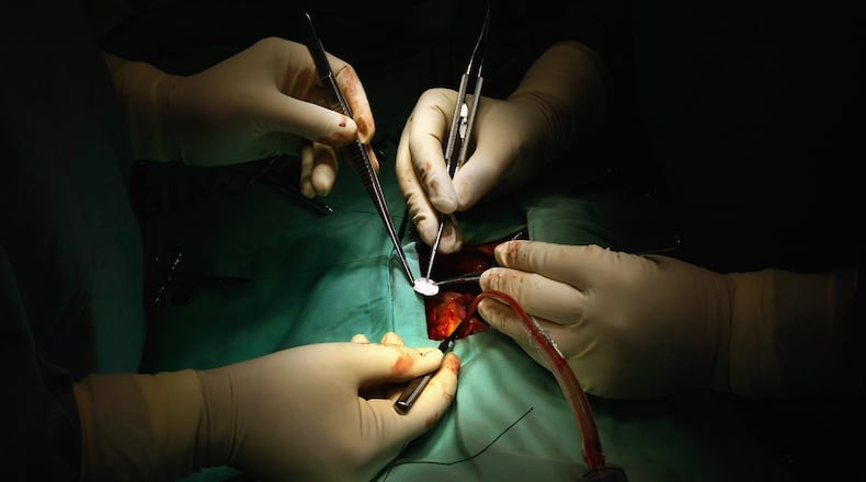 TEL AVIV, ISRAEL - JANUARY 29:  Israeli surgeons prepare a medical patch to cover a hole in Abdullah Siam's heart during his operation at the Wolfson Medical Center January 29, 2009 in Tel Aviv, Israel. The 6-year-old Palestinian boy, whose relative, Hamas Interior Minister Said Siam, was assassinated by Israel during its recent offensive in the Gaza Strip, is the first child from Gaza to cross the border to the Israeli hospital for life-saving heart surgery since the war ended on January 18. Siam was brought over by the Christian charity Shevet Achim to repair the hole in his heart through Save a Child's Heart (SACH), an Israeli-based international humanitarian project whose mission is to improve the quality of paediatric cardiac care for children from developing countries who suffer from heart disease and to create centers of competence in these countries.  (Photo by David Silverman/Getty Images)