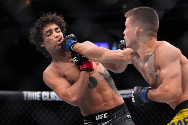 Felipe Lima hits Payton Talbott in a bantamweight fight at UFC 317, Saturday, June 28, 2025, in Las Vegas. (AP Photo/John Locher)
