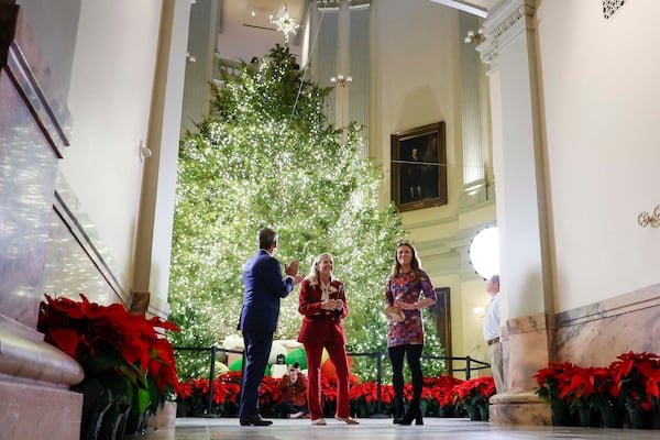 (Left to right): Gov. Brian Kemp, first lady Marty Kemp and their daughter Amy Porter Kemp, were on hand for the lighting of the Capitol Christmas tree in Atlanta on Monday. (Miguel Martinez/AJC)