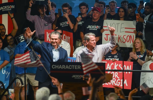 (Left to right) Republican gubernatorial nominee Rick Jackson and Georgia Gov. Brian Kemp wave to supporters from the stage during the Character Matters rally Saturday, Aug. 22, 2026, at Tannery Row in Buford, Ga.(Natrice Miller for The AJC)