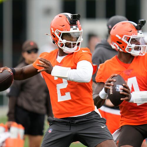 FILE - Cleveland Browns quarterbacks Shedeur Sanders, left, and Deshaun Watson, right, throw during the teams' NFL football practice, Tuesday, June 9, 2026, in Berea, Ohio. (AP Photo/Sue Ogrocki, File)
